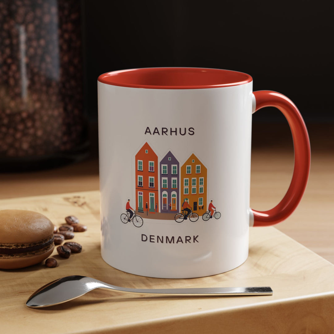 a red and white coffee mug sitting on top of a wooden table