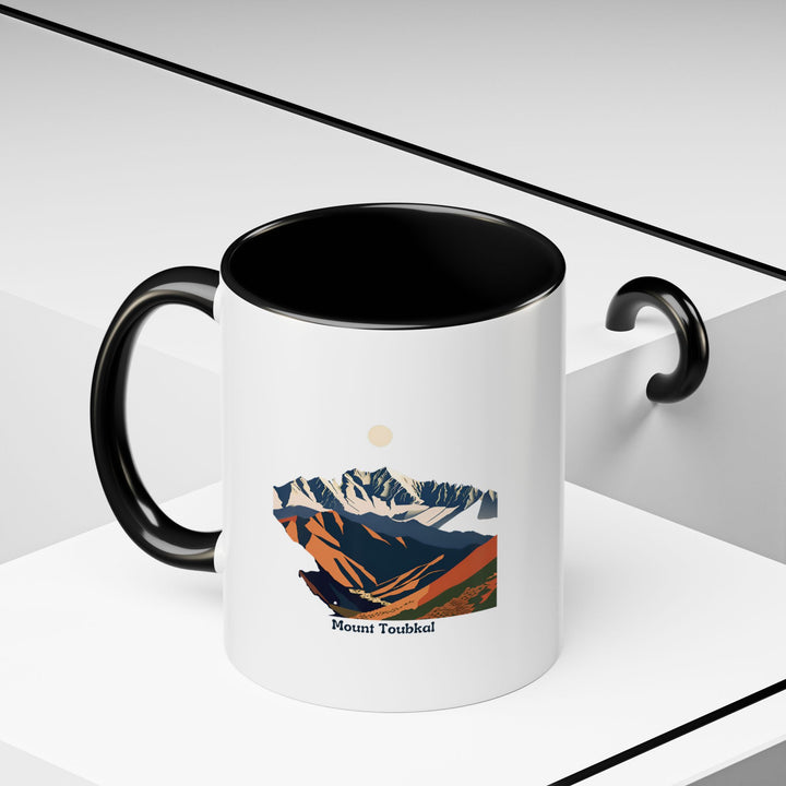 A vibrant Mount Toubkal mug featuring artwork inspired by the natural beauty of Morocco’s highest peak. This durable ceramic mug is perfect for everyday use and is both microwave-safe and dishwasher-safe.