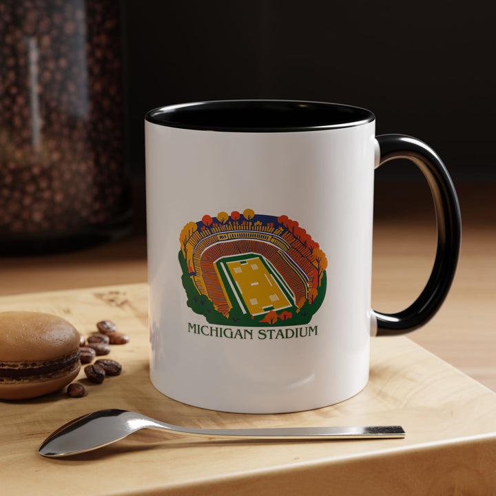 Enjoy your favorite beverage with this Michigan Stadium mug featuring intricate artwork of the legendary stadium. Durable and functional, it is microwave-safe, dishwasher-friendly, and perfect for sports fans.