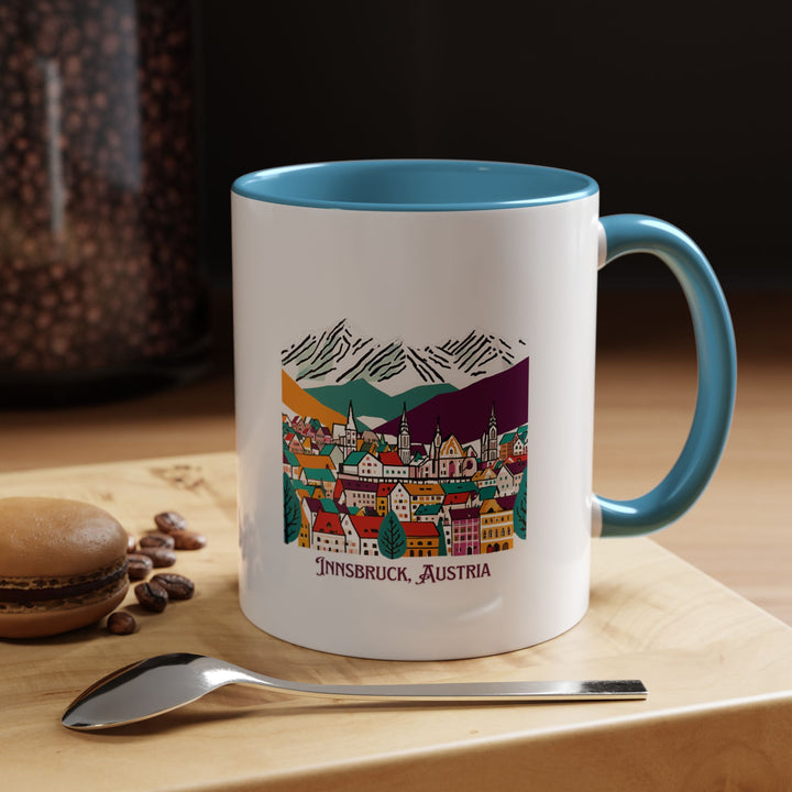 A beautifully designed Innsbruck Austria mug showcasing the city’s alpine charm. Perfect for coffee or tea lovers, it features intricate artwork inspired by Innsbruck’s stunning mountains and architecture. Durable and dishwasher-safe, it makes a meaningful gift or keepsake for travelers.