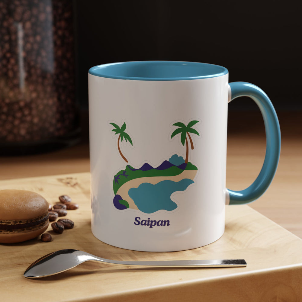 a blue and white coffee mug sitting on top of a wooden table