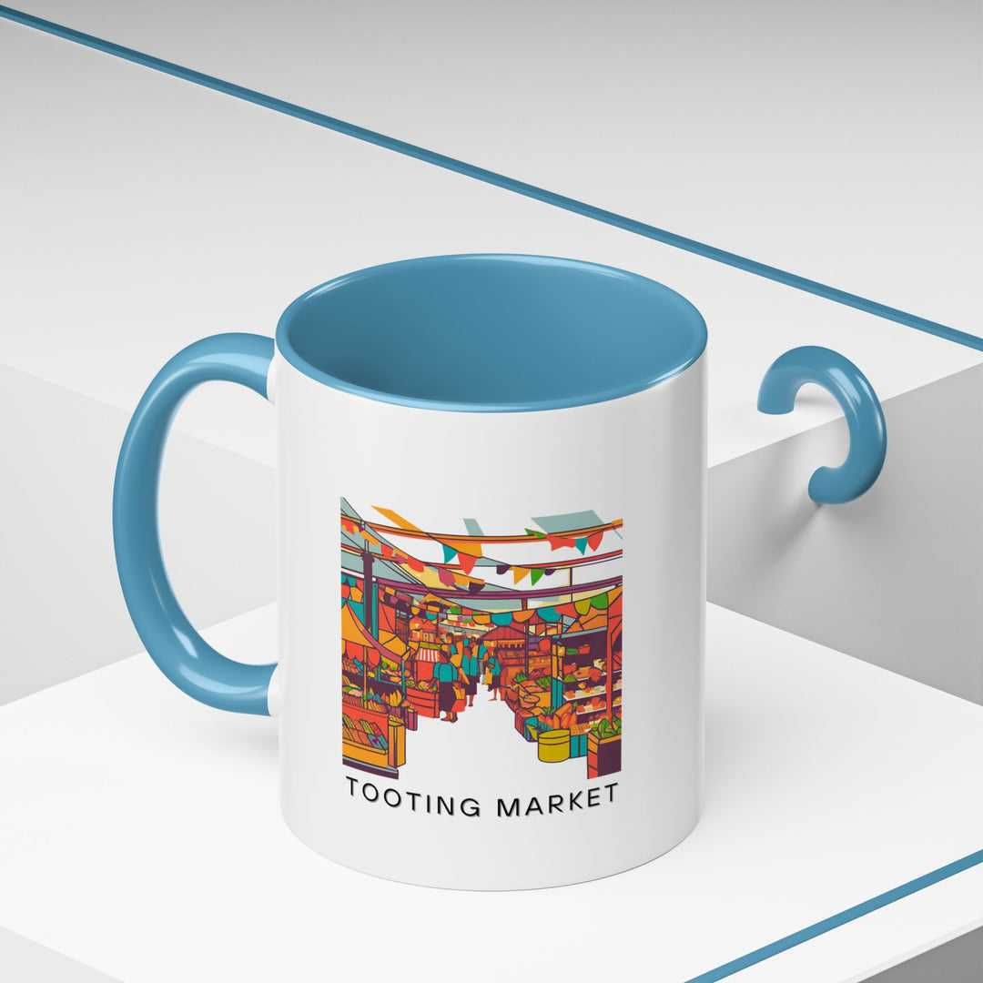 Celebrate the spirit of Tooting Market with this mug showcasing vivid illustrations of its bustling stalls. Dishwasher and microwave safe, it offers style and convenience. Ideal for coffee or tea lovers seeking a unique and artistic addition to their collection.