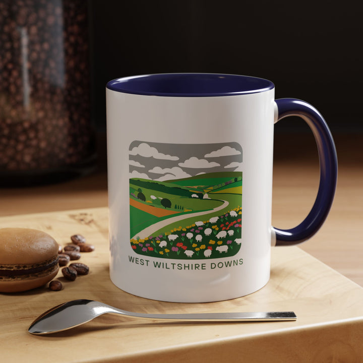 Enjoy your favorite beverage in this West Wiltshire Downs mug showcasing artistic depictions of the region's stunning scenery. Durable and dishwasher-safe, perfect for coffee or tea lovers seeking a touch of rural elegance. A meaningful gift for nature lovers and art enthusiasts.