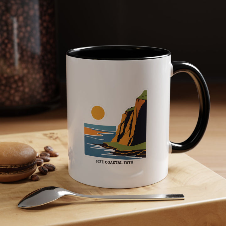 A Fife Coastal Path mug capturing the essence of Scotland’s scenic coastline. This ceramic mug is dishwasher-safe and features vivid colors, making it both functional and artistic. A thoughtful gift for nature lovers.