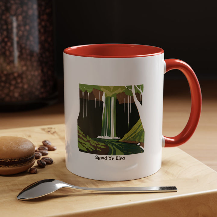 Featuring a detailed depiction of Sgwd Yr Eira, this ceramic mug celebrates the natural beauty of Wales. Dishwasher-safe and microwave-safe, it is perfect for everyday use or as a meaningful gift.