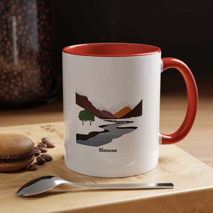 A ceramic Glencoe mug showcasing beautiful artwork of the Scottish Highlands. Perfect for coffee or tea, it features a colorful interior, durable build, and dishwasher-safe design, making it an ideal gift for travelers and Highland enthusiasts.