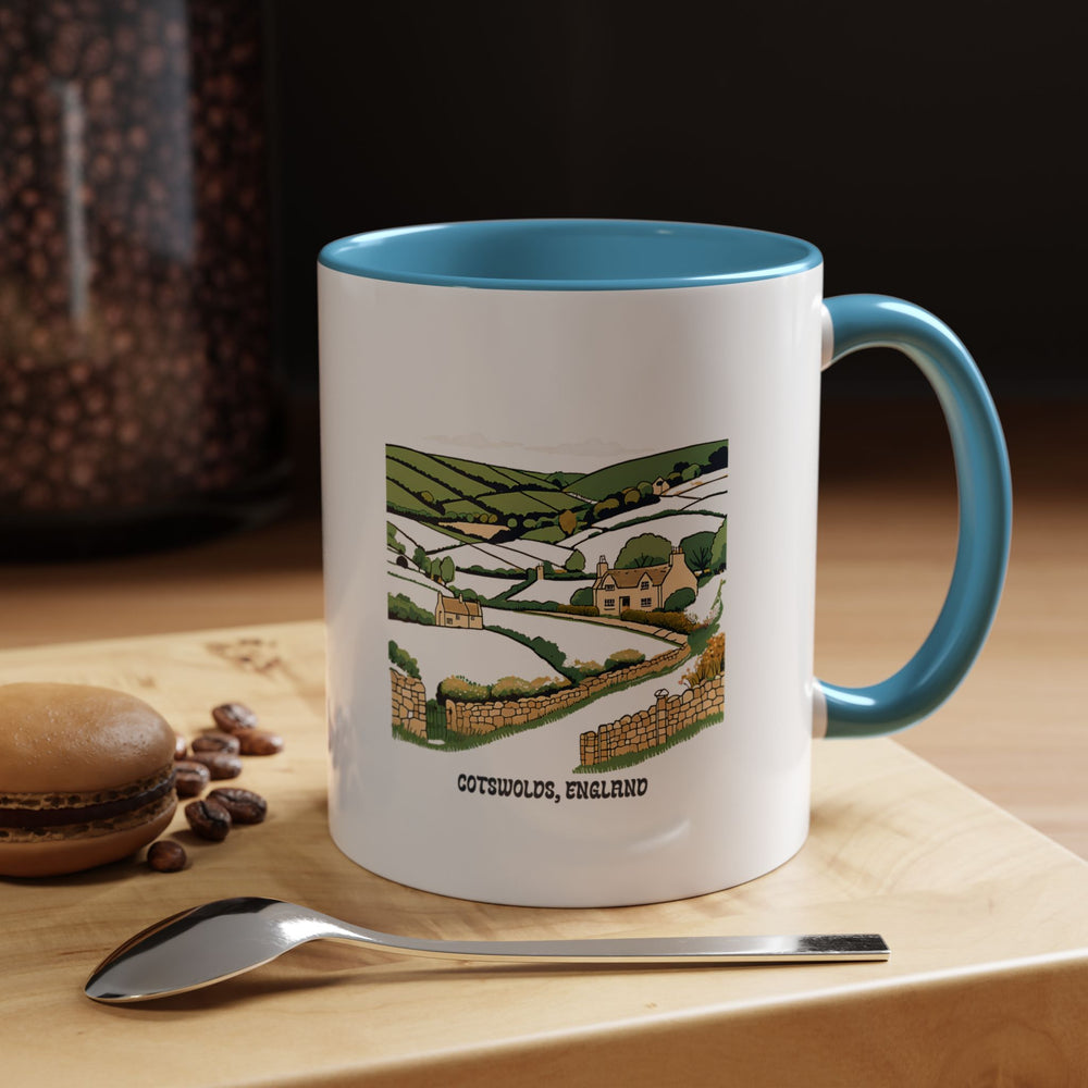 This Cotswolds England mug showcases intricate artwork of the countryside. Dishwasher-safe ceramic ensures practicality, making it a stylish and functional gift or keepsake for fans of English landscapes and coffee enthusiasts.