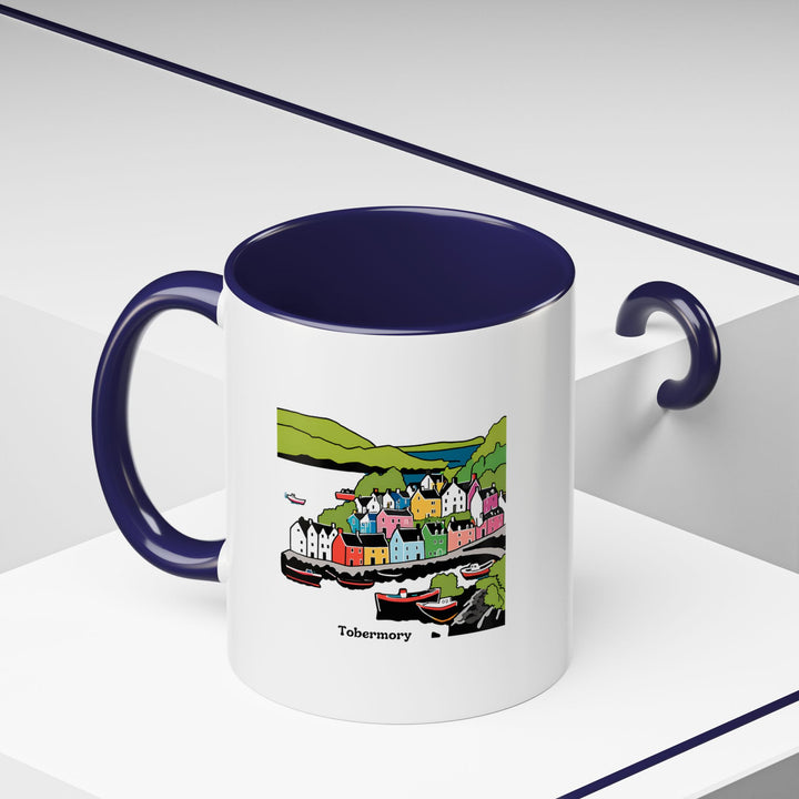 Celebrate the allure of Tobermory with this artistically crafted mug. Perfect for coffee or tea, it features colorful designs of the town landmarks. Durable and dishwasher safe, it is a practical addition to any kitchen or office and a great gift idea.