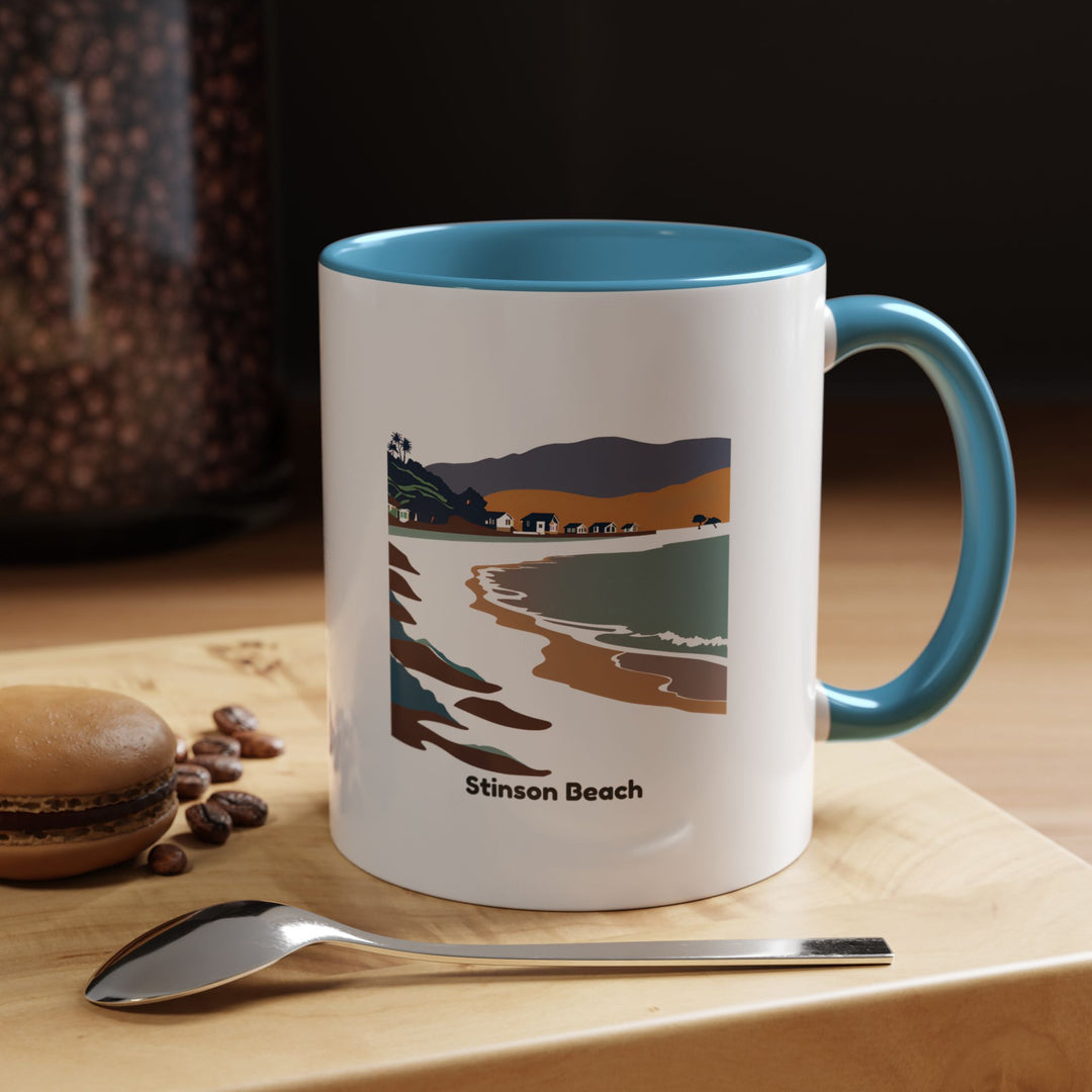 A ceramic Stinson Beach Mug showcasing a stunning coastal view. This dishwasher-safe mug is perfect for enjoying your favorite beverages while reliving the peacefulness of the beach. Its vibrant design adds a personal touch to any collection.