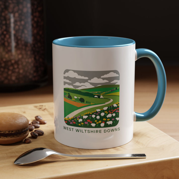 This West Wiltshire Downs mug combines practical function with artistic beauty, displaying intricate artwork of the area's vibrant landscapes. Made from high-quality ceramic, dishwasher and microwave safe, suitable for everyday use or as a special keepsake for those who love the countryside.