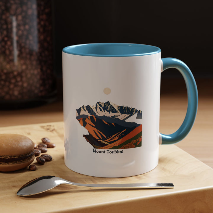 A beautifully crafted Mount Toubkal mug showcasing the natural beauty of Morocco’s highest mountain. Made from durable ceramic, this mug is ideal for hot beverages and is dishwasher-safe for convenience.