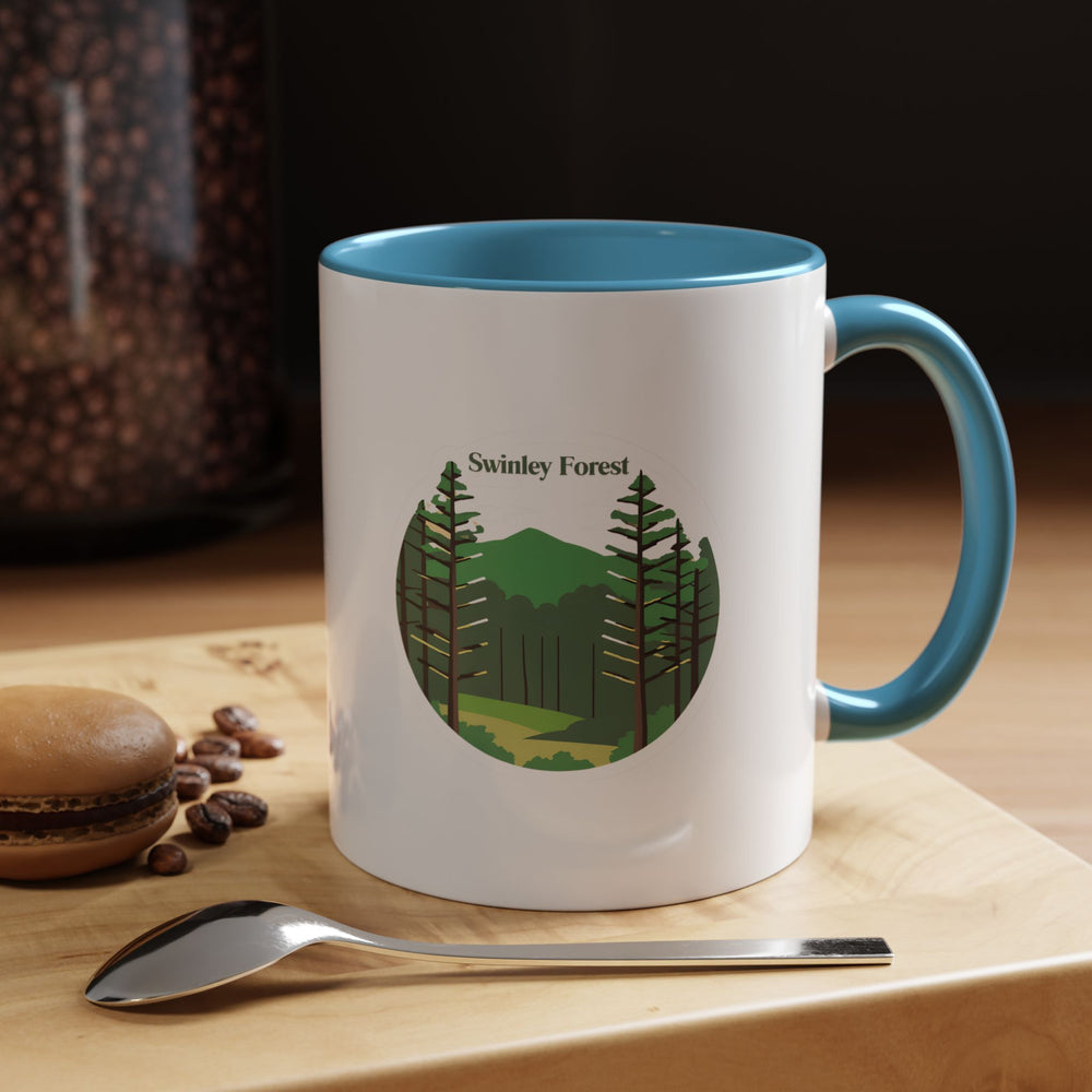 Experience the serenity of Swinley Forest with this elegant mug showcasing detailed illustrations of its iconic woodlands. Made from durable ceramic, dishwasher and microwave safe, it is ideal for daily use or as a thoughtful gift for fans and collectors of Swinley Forest mugs.