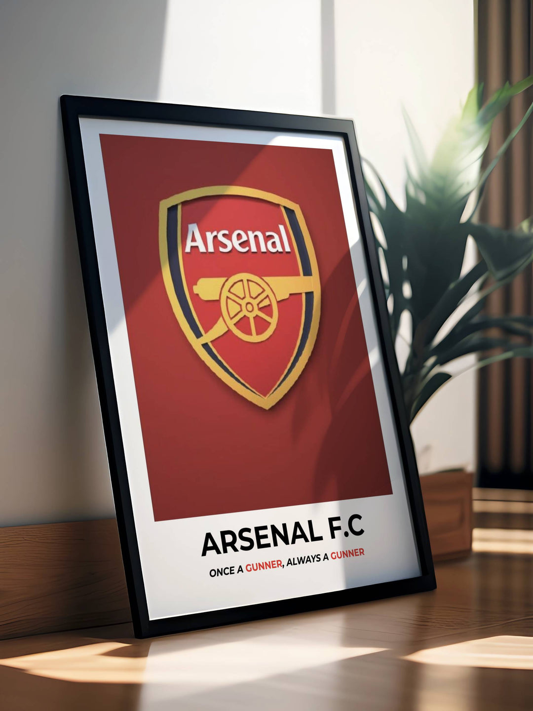 Premium framed Arsenal F.C. heritage shield poster from MapYourDreams featuring a minimalist gold club crest on a deep crimson red background with the text Once a Gunner Always a Gunner.