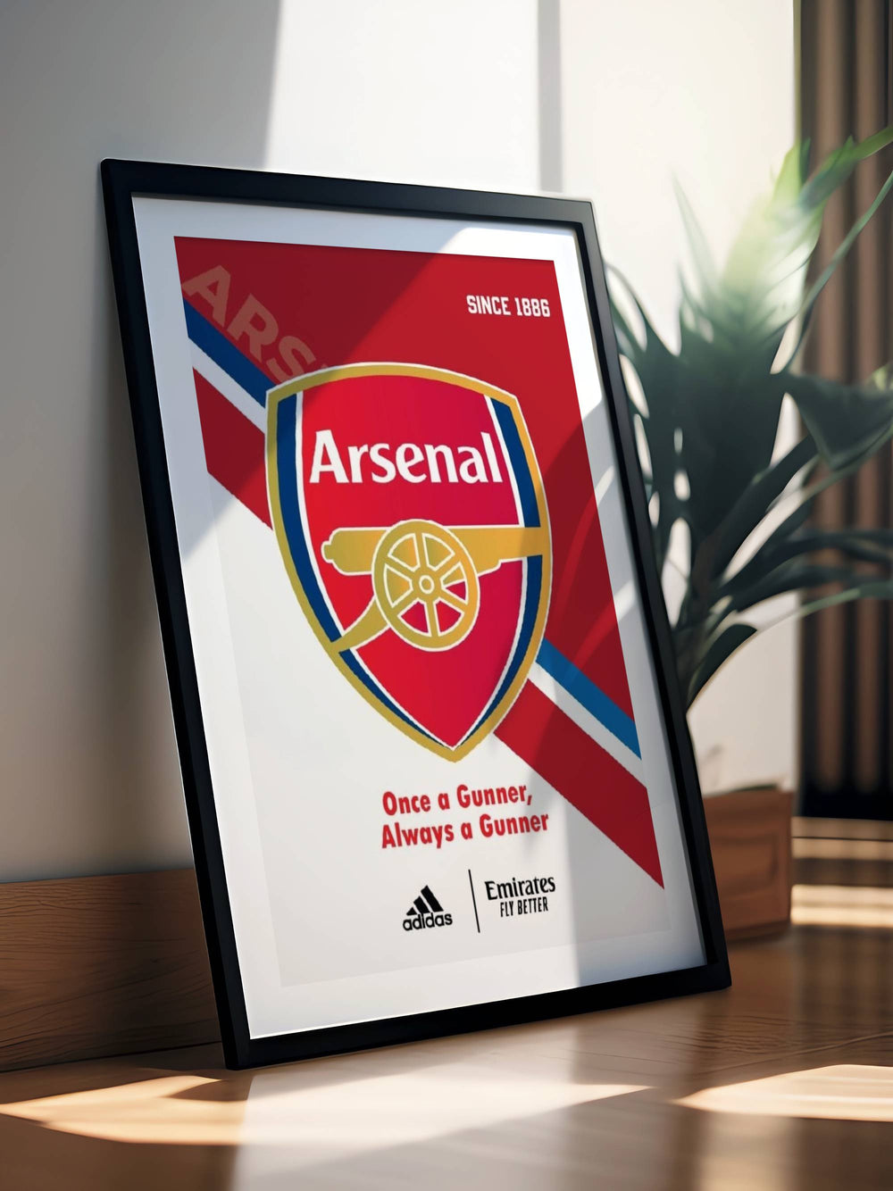 Premium Arsenal football wall art print with official club crest, Since 1886 text, and sport kit branding at the base, showcased beautifully with a wide white mat and minimalist black frame.