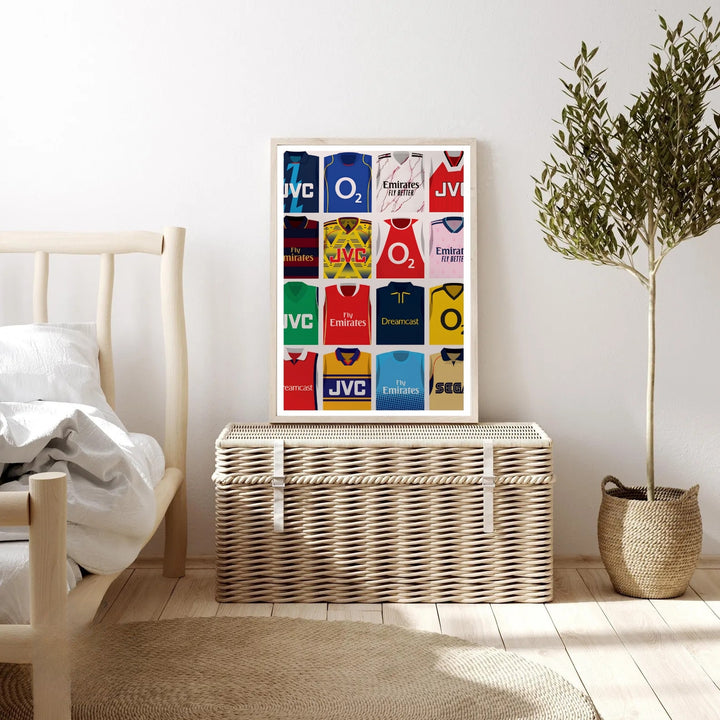 Illustrated Arsenal FC kit grid poster showing sponsor jerseys including O2, Fly Emirates, JVC, Dreamcast, and Sega, worn by the North London club across different eras, available as canvas, framed, or unframed wall art.