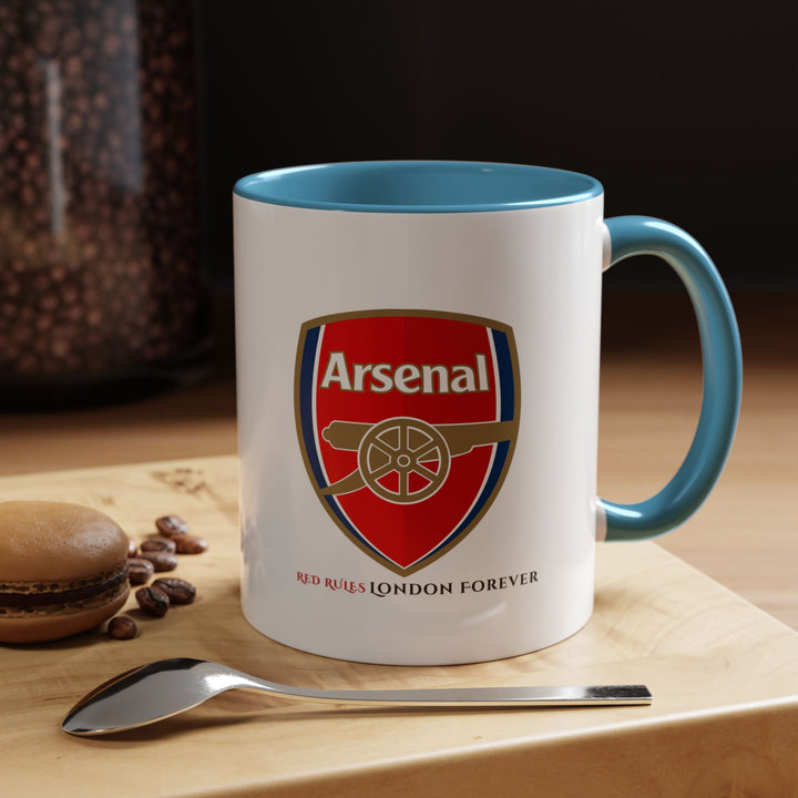 Blue Arsenal mug featuring the club logo and detailed Emirates Stadium illustration. Designed for football fans who love stylish supporter drinkware. Ceramic tea and coffee cup suitable for daily use or display, created by Map Your Dreams for Arsenal lovers, collectors, and thoughtful gift giving.