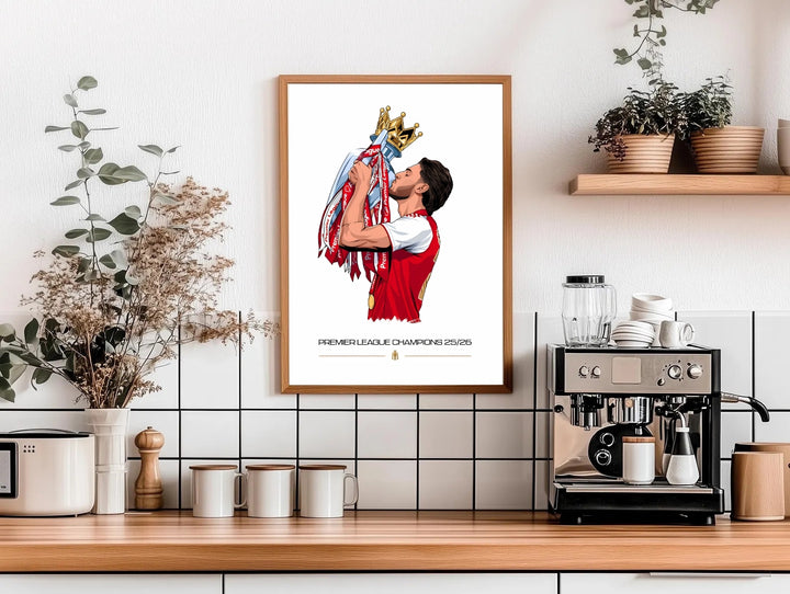 Declan Rice Champions 25/26 poster depicting the Arsenal FC midfielder crowned in gold lifting the Premier League trophy to his lips, a bold celebration print for North London football fans, available framed, unframed, or on canvas.