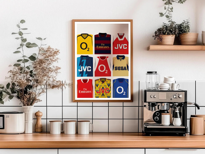 Illustrated Arsenal FC kit grid poster showing sponsor jerseys including O2, Fly Emirates, JVC, and Sega, worn by the North London club across different eras, available as canvas, framed, or unframed wall art.