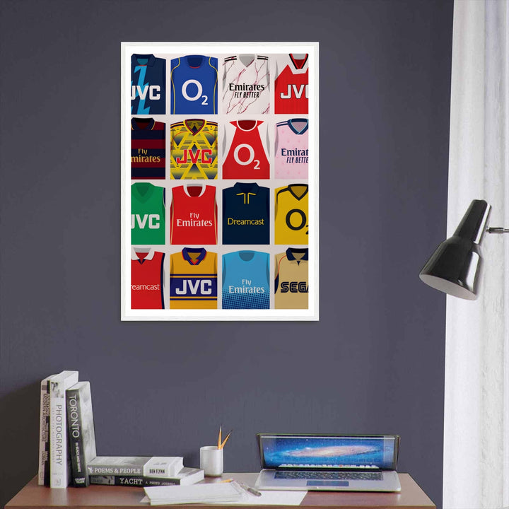 Retro Arsenal FC kit evolution print showcasing the "bruised banana" jersey, maroon-and-navy hoops, and marble-effect Fly Better shirt worn by the North London side across eras, offered as unframed, framed, or canvas wall art.