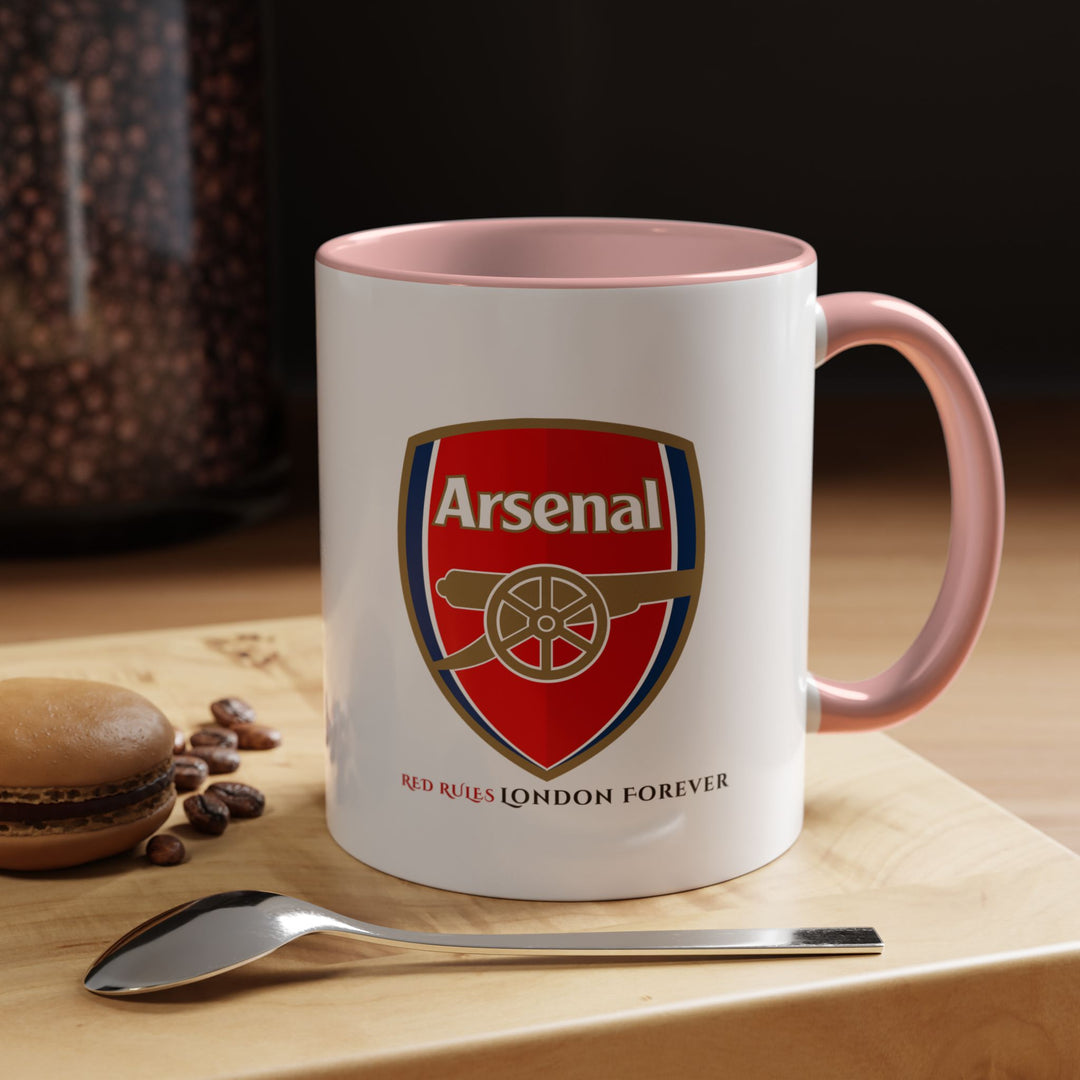 Pink Arsenal supporter mug with the official Arsenal logo and artistic Emirates Stadium design. A standout collectible and practical tea or coffee cup for fans who enjoy vibrant colors. Perfect for office desks, home kitchens, match day routines, and display shelves. Crafted by Map Your Dreams.