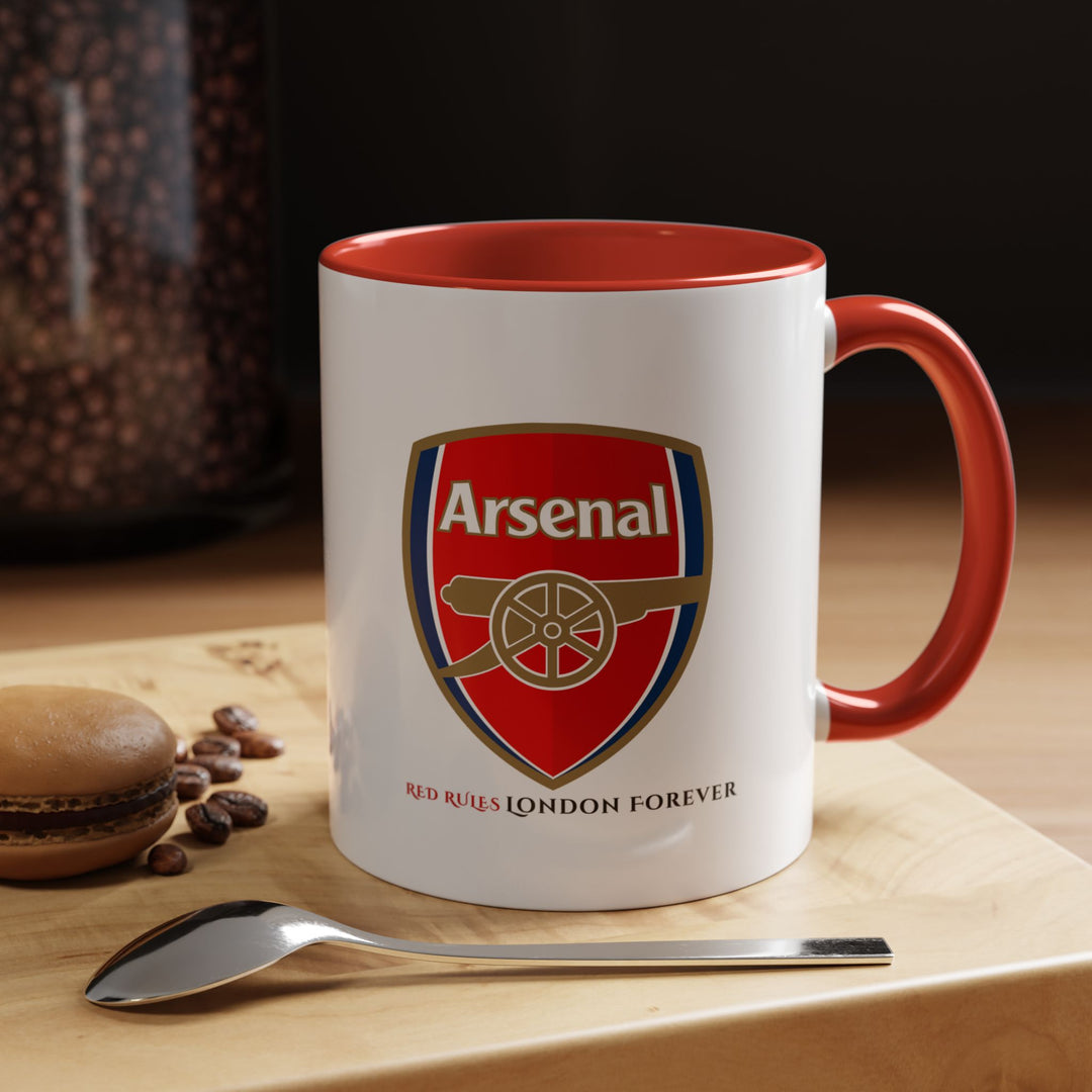 Red Arsenal coffee mug with the official Arsenal logo and Emirates Stadium artwork. A bold fan cup for tea, coffee, or display. Ideal for Arsenal supporters looking to show club pride daily. Durable ceramic drinkware created by Map Your Dreams, perfect for collections, gifting, office use, and match day excitement.