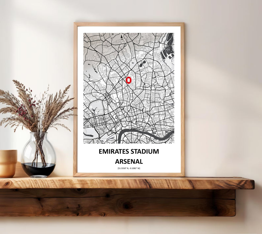 Monochrome map print pinpointing the Emirates Stadium within the North London street grid, showing the surrounding roads and a glimpse of the River Thames, offered as unframed, framed, or canvas wall art for Arsenal fans.