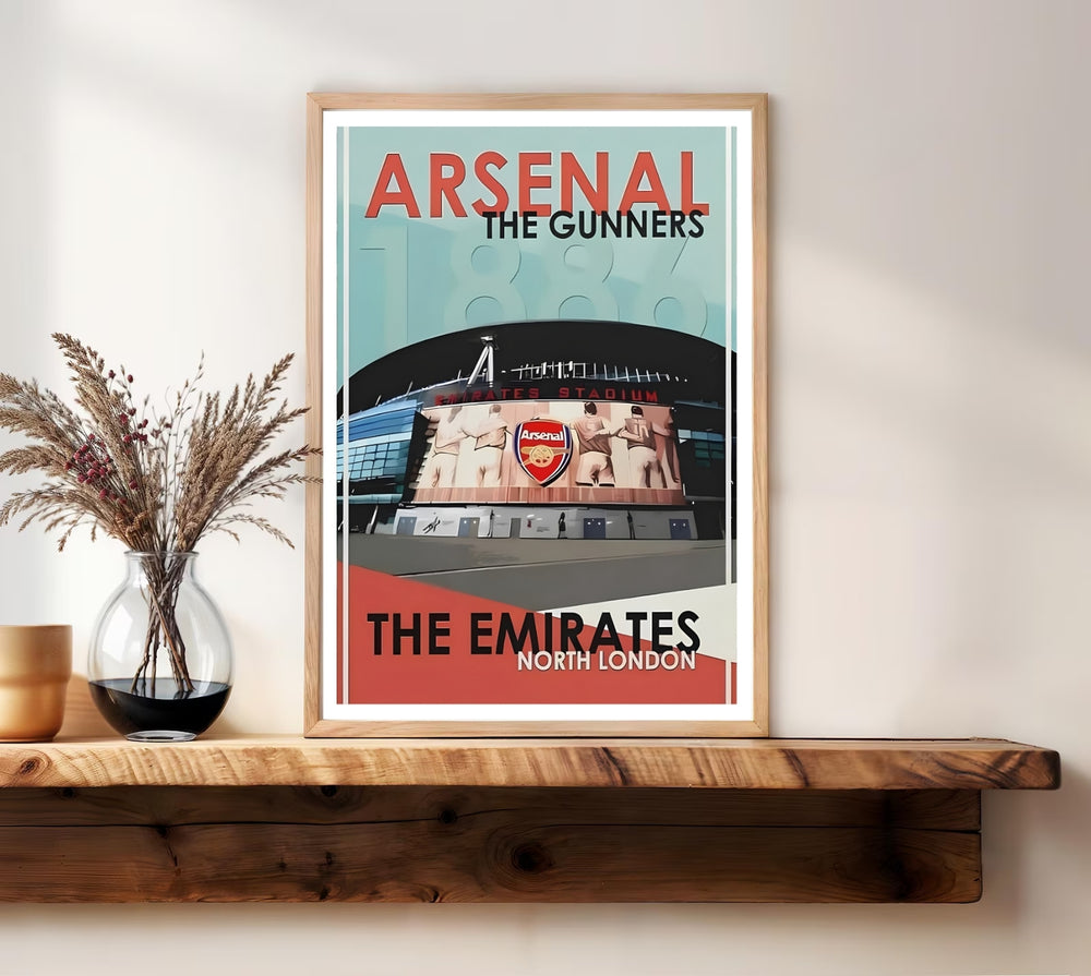 Emirates Stadium poster showing the entrance and iconic Arsenal crest mural above the doors, set in North London with a faded 1886 founding-year watermark, offered as unframed, framed, or canvas wall art.