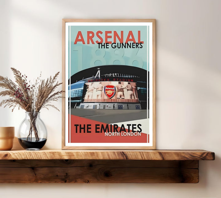 Emirates Stadium poster showing the entrance and iconic Arsenal crest mural above the doors, set in North London with a faded 1886 founding-year watermark, offered as unframed, framed, or canvas wall art.