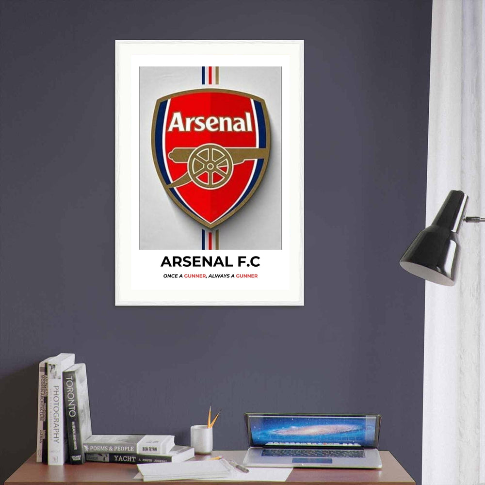 High-quality Arsenal football wall decor showing the official team badge print with a 3D shadow effect over minimalist red, navy blue, and gold vertical stripes on a premium poster background.