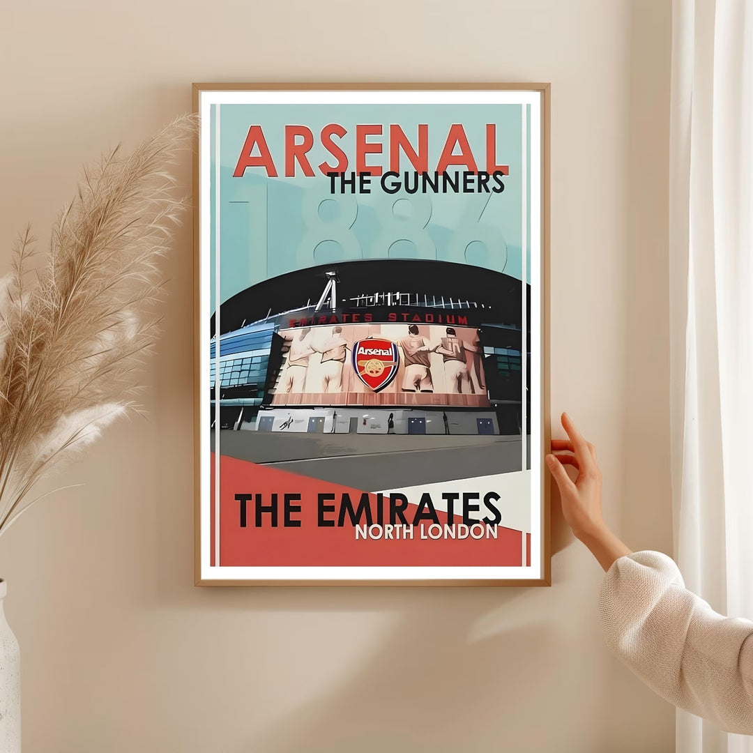 Arsenal FC travel poster capturing the Emirates Stadium exterior in North London, with bold "Arsenal, The Gunners" lettering and a classic vintage color palette, available in framed, unframed, and canvas formats.