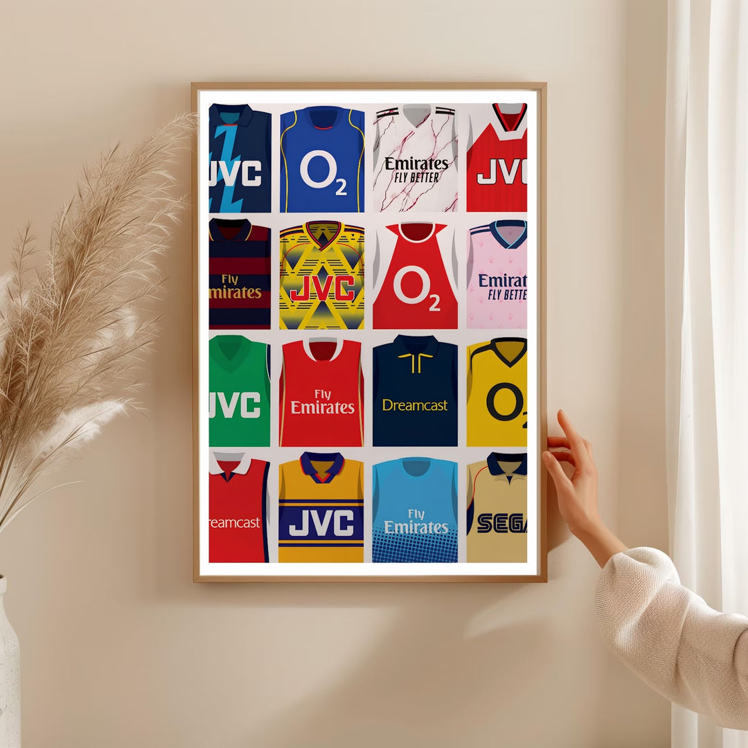 Football wall art print featuring sixteen iconic Arsenal FC jerseys, including O2, JVC, and Fly Emirates sponsor kits worn by the North London club, available as a canvas, framed, or unframed print.