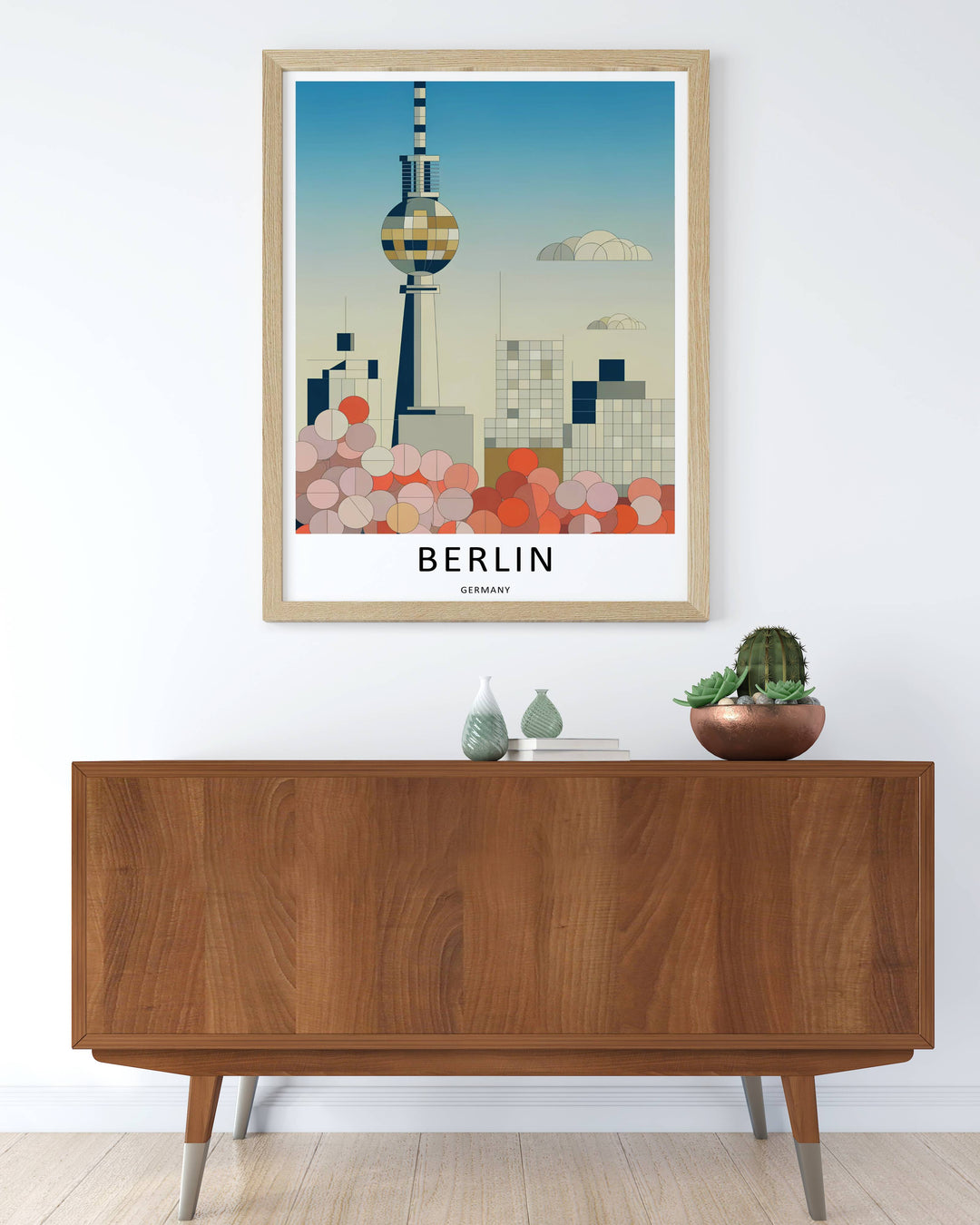 Artistic office wall decor layout featuring a mid century modern Berlin Germany travel poster highlighting the Fernsehturm TV Tower above stylized minimalist cityscape windows and buildings.