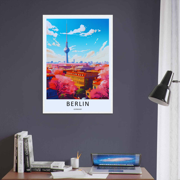 Framed graphic illustration of the Berlin Germany cityscape. The artwork features a stunning contrast of bright pink cherry blossom canopy against a clear blue sky with white clouds.