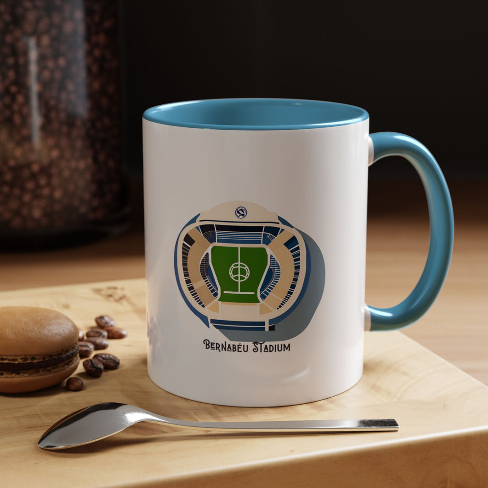 Santiago Bernabéu stadium inspired Real Madrid mug in blue. Features visual elements reflecting the stadium’s distinctive exterior and match-day feel, ideal for supporters who love the legacy and identity of the venue. A thoughtful fan gift and everyday drinkware piece that brings the spirit of Real Madrid into office desks, home kitchens, study setups, or match day viewing spaces.