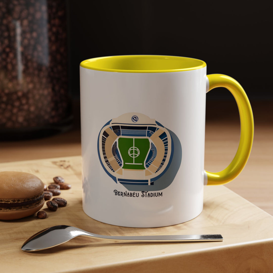 Santiago Bernabéu stadium coffee and tea mug in bright yellow. The artwork captures the energy and excitement surrounding Real Madrid’s home ground, making it a vibrant choice for supporters who love bold, expressive colors. Ideal for gifting, daily use, or adding character to a Real Madrid supporter’s display shelf, kitchen, or match day ritual setup.