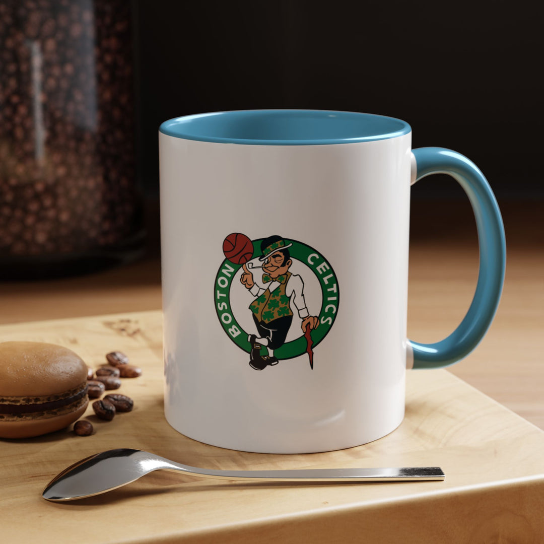 A Boston Celtics fan mug in blue ceramic, crafted to deliver both style and functionality. Ideal for coffee, tea, or hot chocolate, it showcases a vibrant, classic color that complements any NBA collection. Durable and eye-catching, this mug is perfect for game-day rituals, office desks, or gifting to dedicated Celtics enthusiasts.