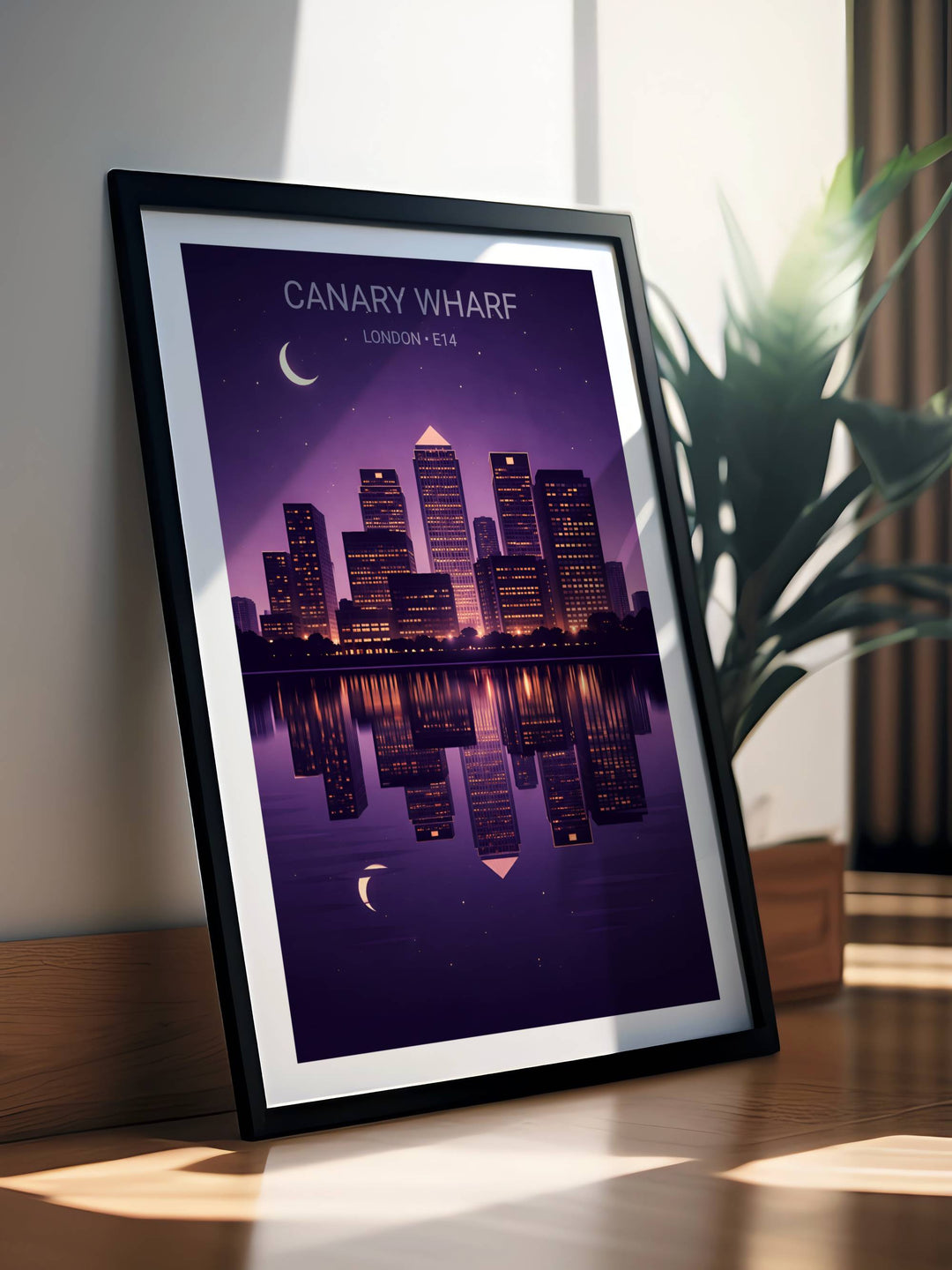 Framed poster of Canary Wharf skyline with a purple color scheme on a wooden surface.