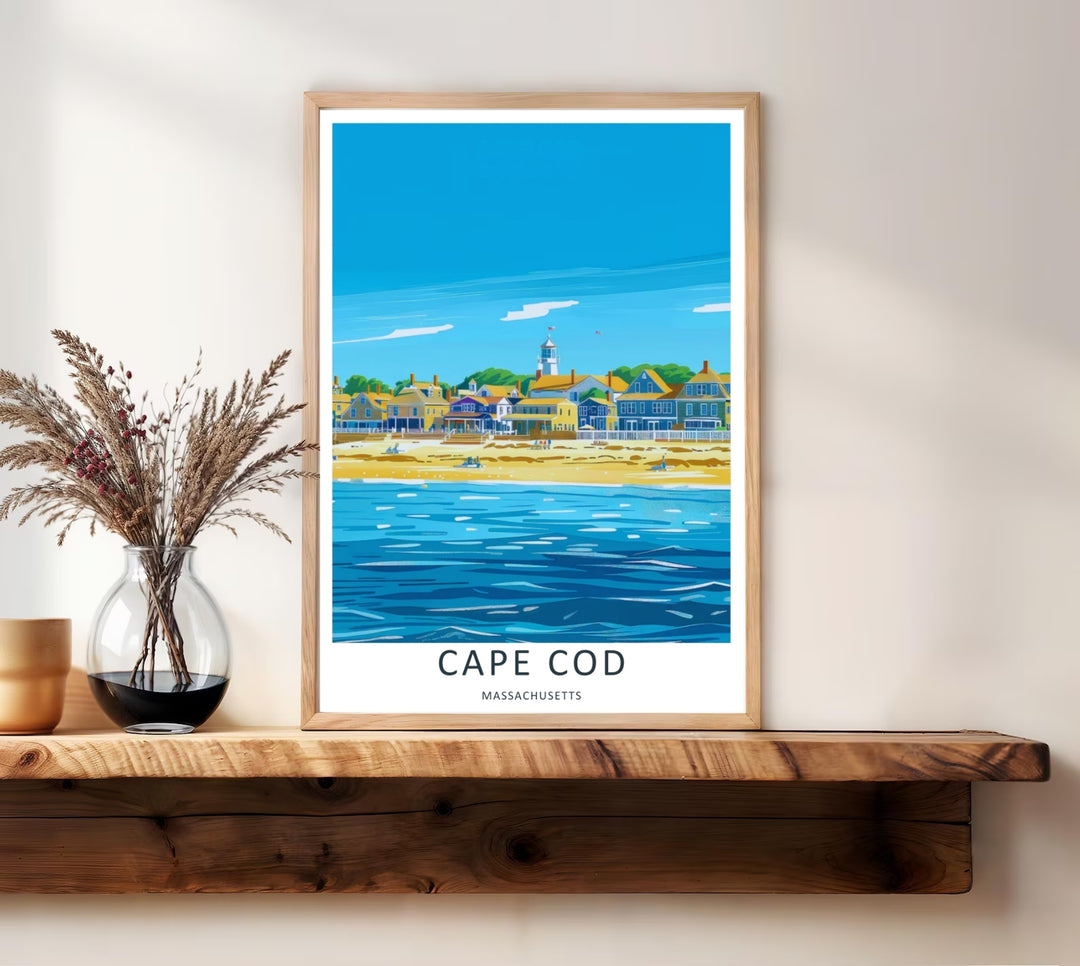 Cape Cod coastal print showing a sunny golden sand beach and calm ocean waves in front of a historic waterfront village. High-quality wall decor available in versatile framed and unframed print options.