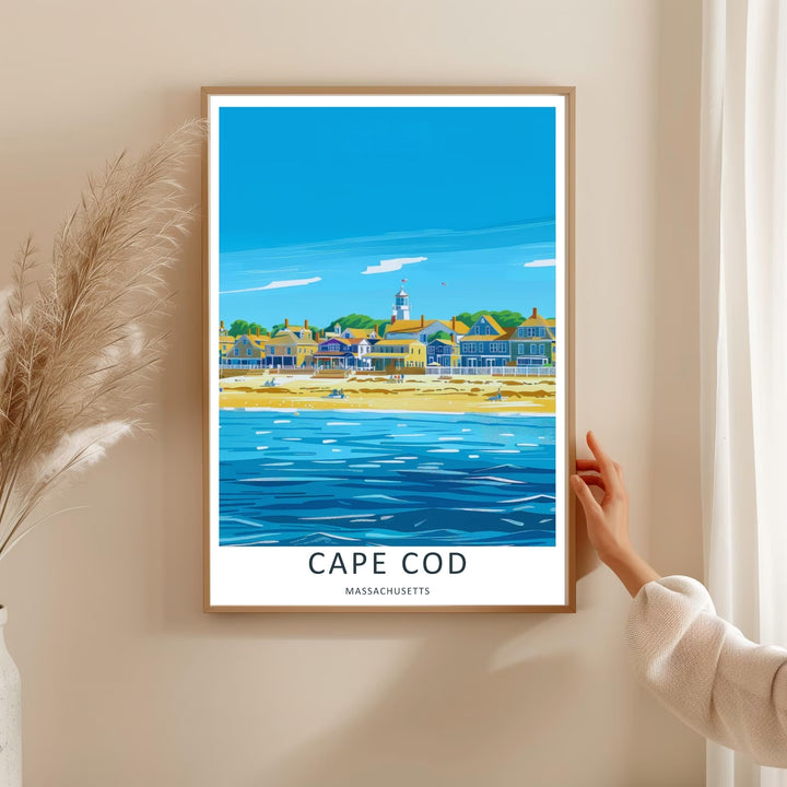 Cape Cod maritime wall art depicting an expansive deep blue ocean with a white lighthouse peeking out behind coastal houses. This MapYourDreams decorative poster can be purchased as a premium framed art piece.