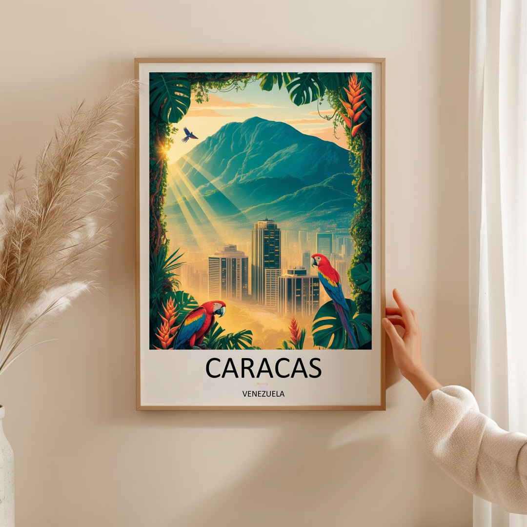 Tropical city wall art print framed by dark green monstera leaves and orange heliconia flowers, showcasing a golden-hour sunburst breaking across a hazy, atmospheric Caracas cityscape valley.