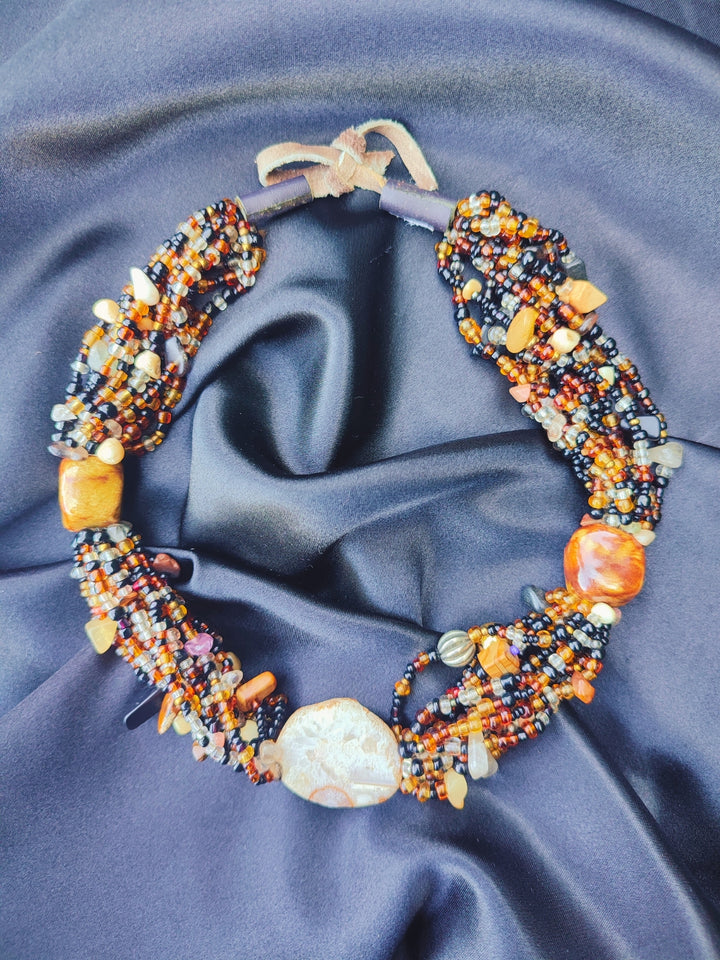 Handcrafted multi-strand earthy seed bead choker with large agate stone focal point.