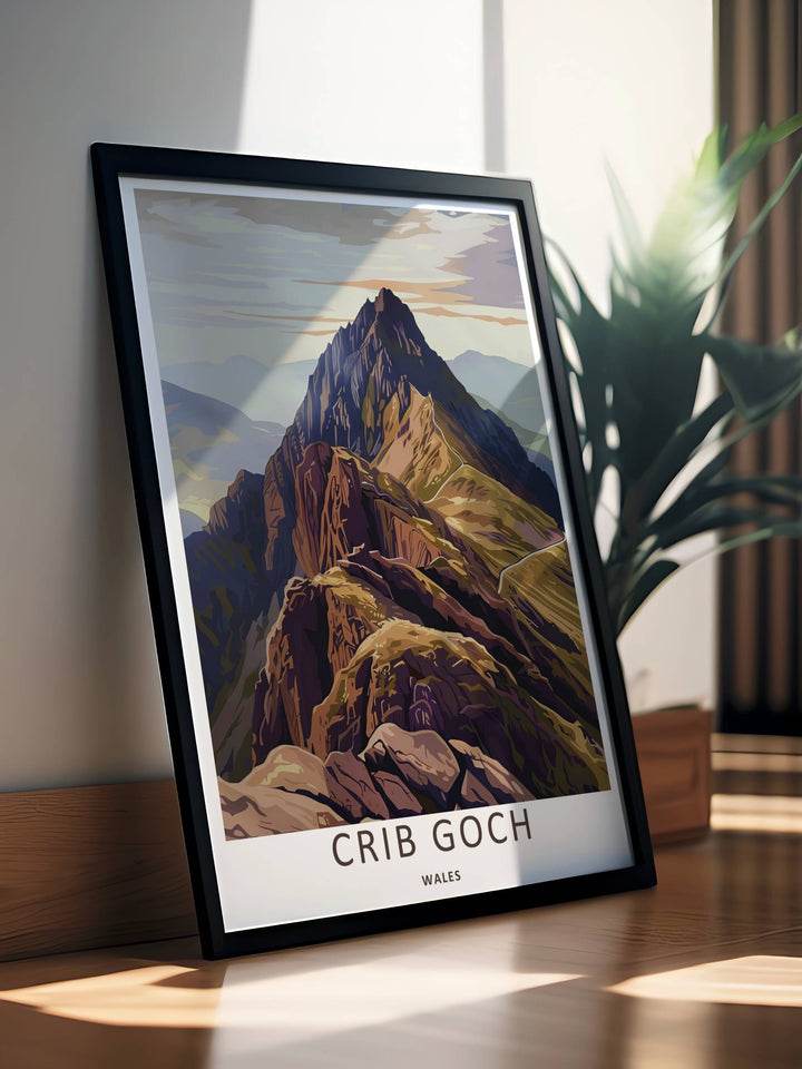 An evocative alpine print of the peak of Crib Goch in Wales featuring rich charcoal grey tones and dramatic dark shadows, available to purchase as a canvas print or a premium bronze frame.