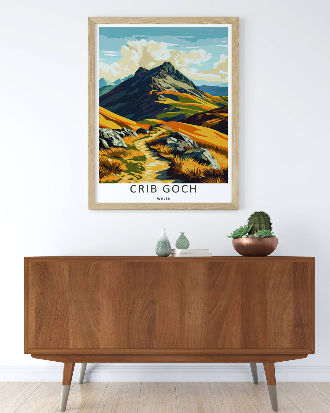 Modern travel poster art featuring a retro vector layout of the classic Crib Goch mountain range, which can be ordered as a stretched canvas, an unframed poster, or a framed print. The landscape art details the sharp graphic contrasts of the sharp knife-edge ridge.