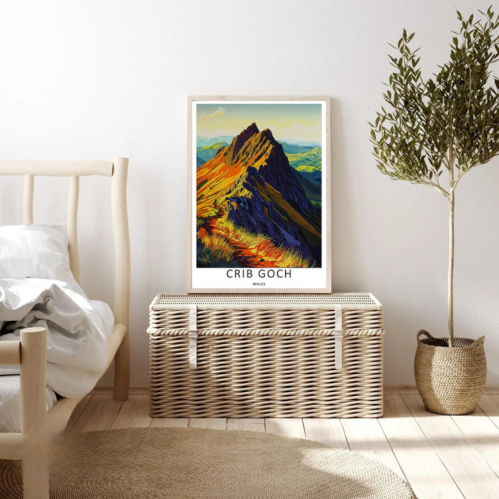 An evocative high-altitude landscape print of Crib Goch in Wales featuring rich terracotta orange and dark indigo block colors, available to purchase as a canvas print or a premium bronze frame.
