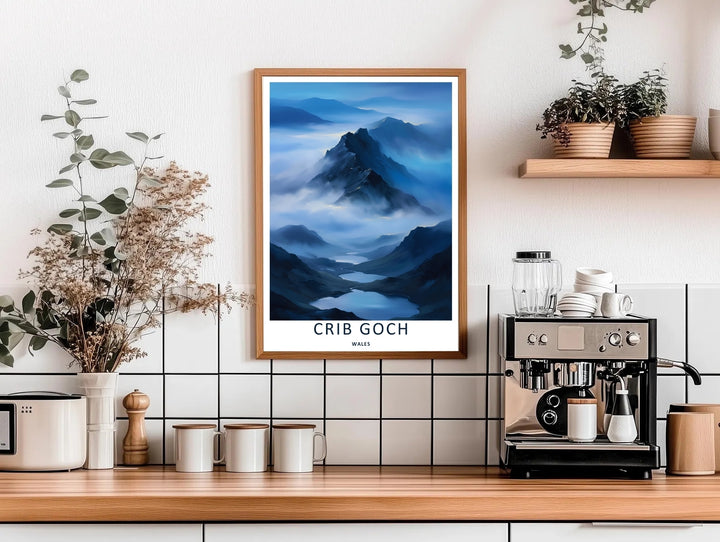 High-contrast illustrative artwork of the cloud-covered Crib Goch mountain trail, custom made as a canvas, a standalone unframed print, or a framed poster. The design uses layered textures and dark blue tones to show a scenic mountain peak.