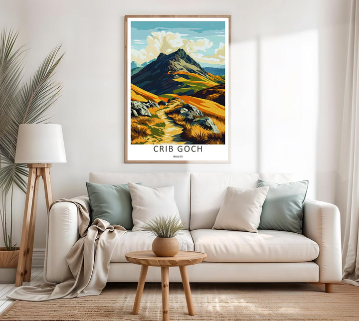 A colorful travel poster design of the scenic Crib Goch mountain peak, available in a variety of presentation formats including unframed prints, canvas wall art, and framed finishes. The print highlights the golden grass fields stretching below the steep ridge.