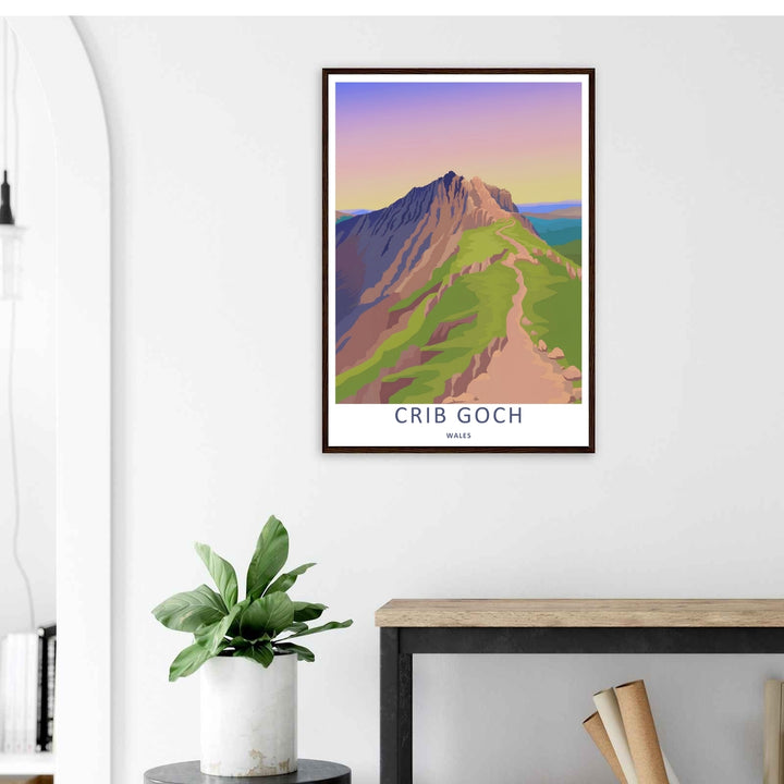 A stylized landscape print displaying a vintage Crib Goch mountain travel poster, with options to purchase as an unframed print, a high-quality canvas, or a framed display. The artwork balances vibrant green hills against warm evening mountain rock.