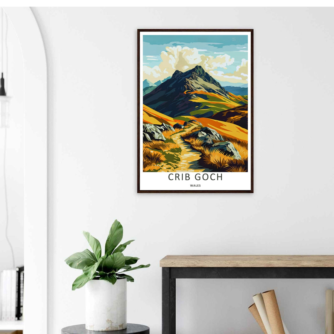 A stylized landscape print displaying a vintage Crib Goch mountain travel poster, with options to purchase as an unframed print, a high-quality canvas, or a framed display. The artwork balances vibrant ochre hills against dark teal and blue mountain rock.