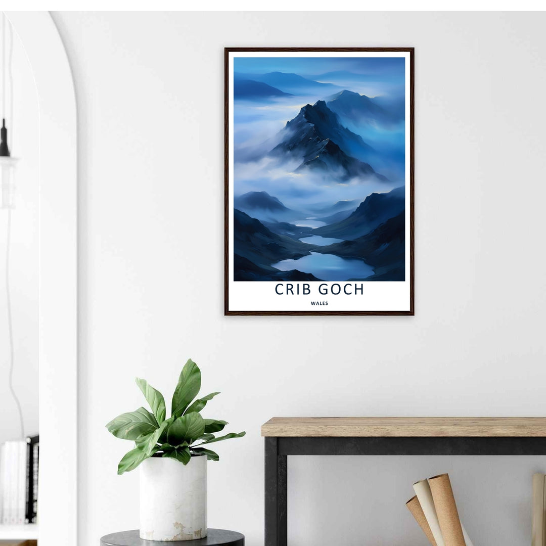 A stylized landscape print displaying a vintage Crib Goch mountain travel poster, with options to purchase as an unframed print, a high-quality canvas, or a framed display. The artwork balances deep navy blue rock against soft morning valley fog.