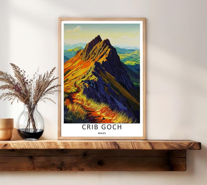 Richly colored Welsh landscape wall decor showing a dramatic sunset view over the high peak of Crib Goch in Wales, presented inside a classic white frame to elevate a modern living room gallery.